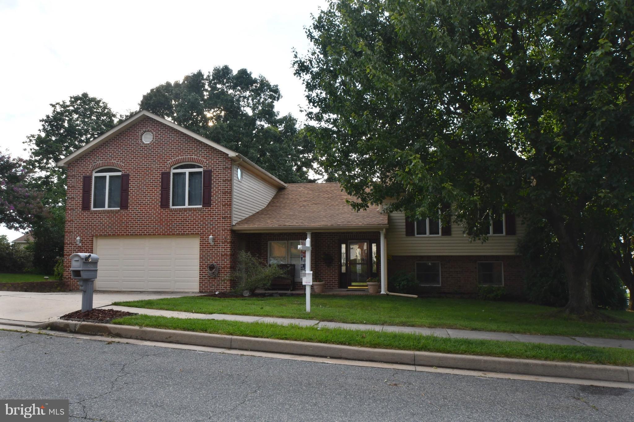 202 Sandhill Road Baltimore, MD 21221 - Photo 2 of 30 a front view of a house with a yard