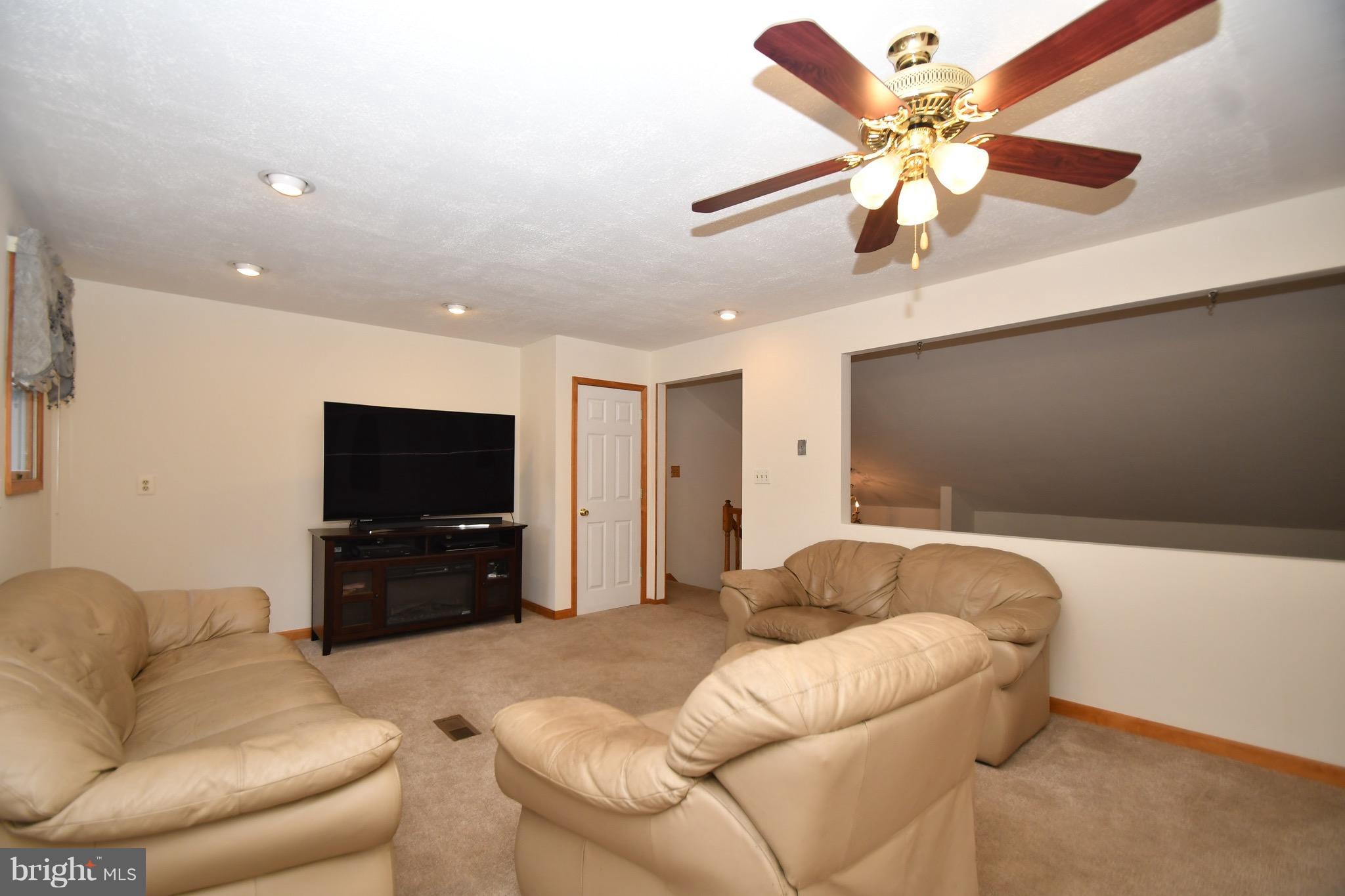 202 Sandhill Road Baltimore, MD 21221 - Photo 12 of 30 a living room with furniture and a flat screen tv
