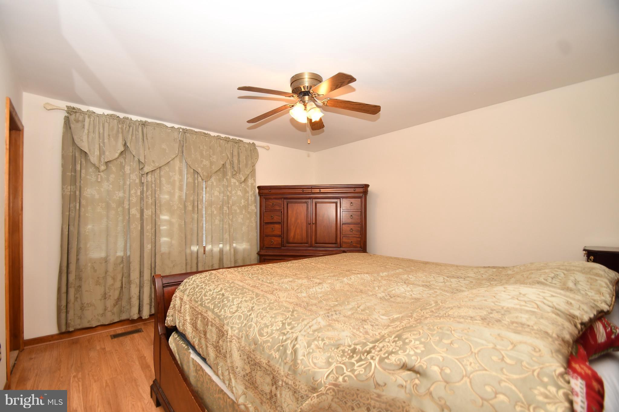 202 Sandhill Road Baltimore, MD 21221 - Photo 14 of 30 a bedroom with a bed and a chandelier