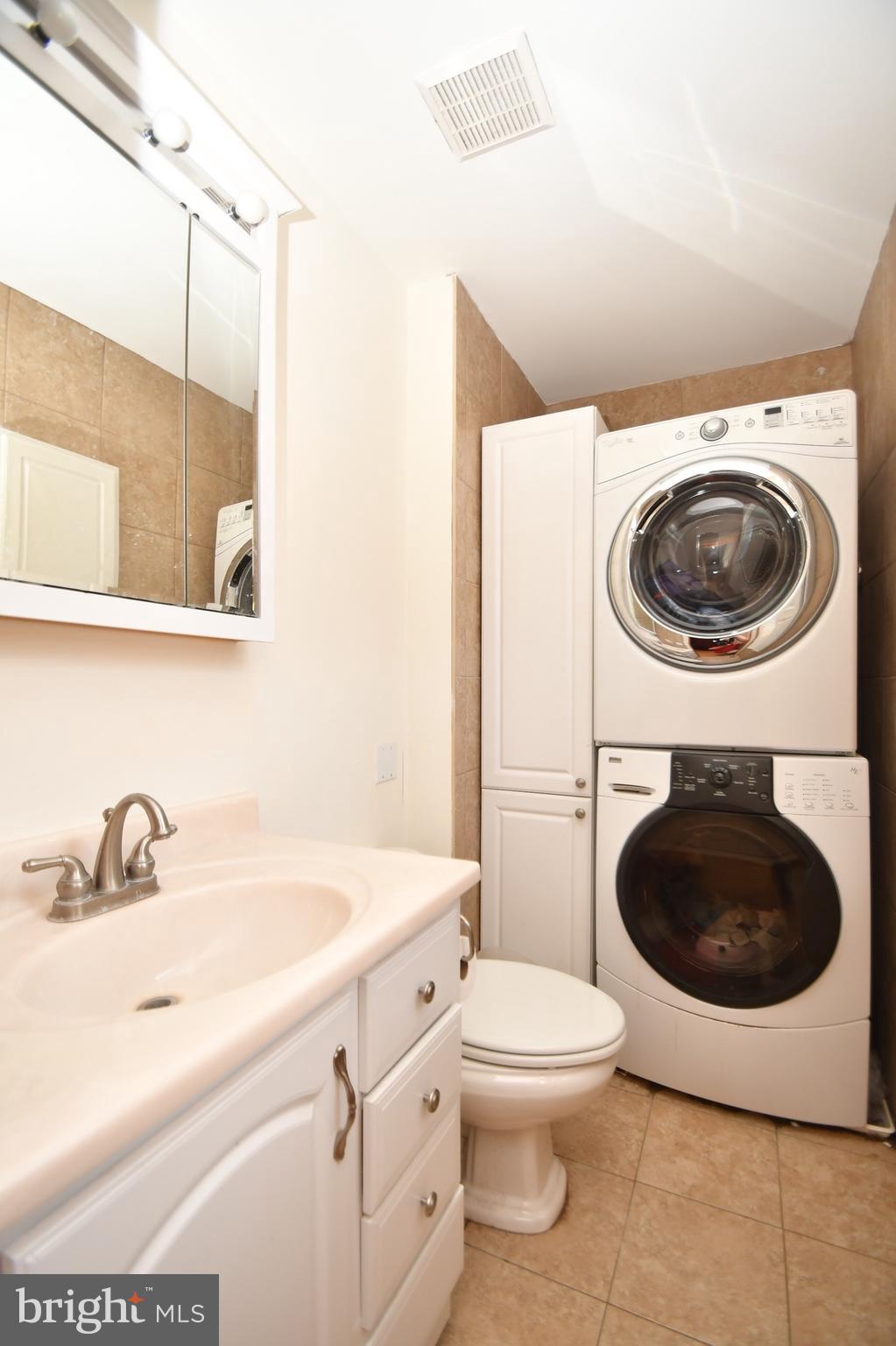 202 Sandhill Road Baltimore, MD 21221 - Photo 15 of 30 a bathroom with a sink a toilet and a mirror