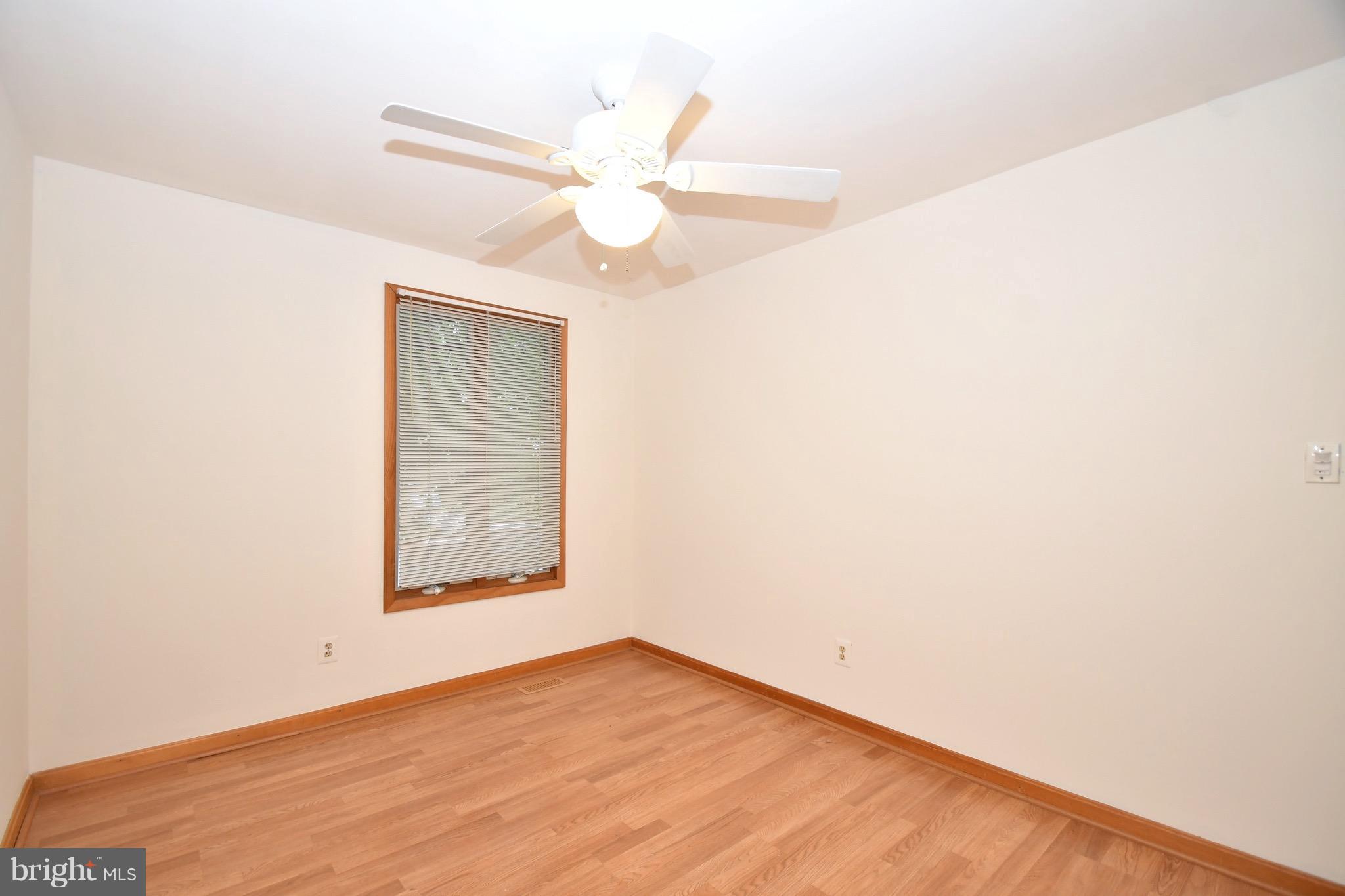 202 Sandhill Road Baltimore, MD 21221 - Photo 16 of 30 an empty room with a window and ceiling fan