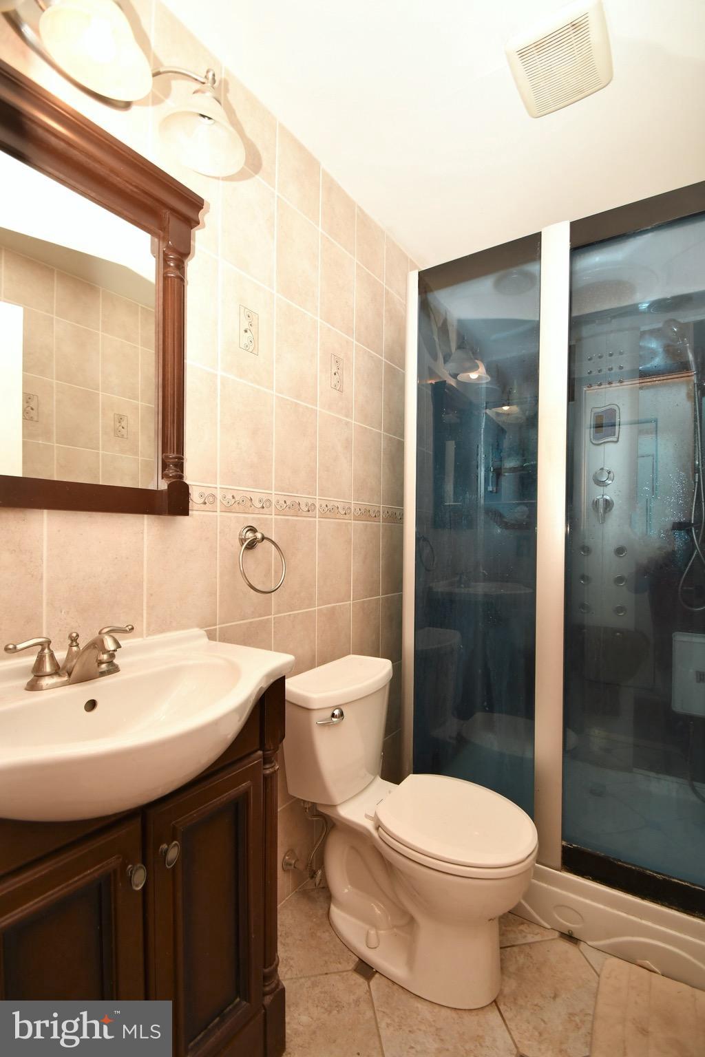 202 Sandhill Road Baltimore, MD 21221 - Photo 20 of 30 a bathroom with a sink a toilet and shower