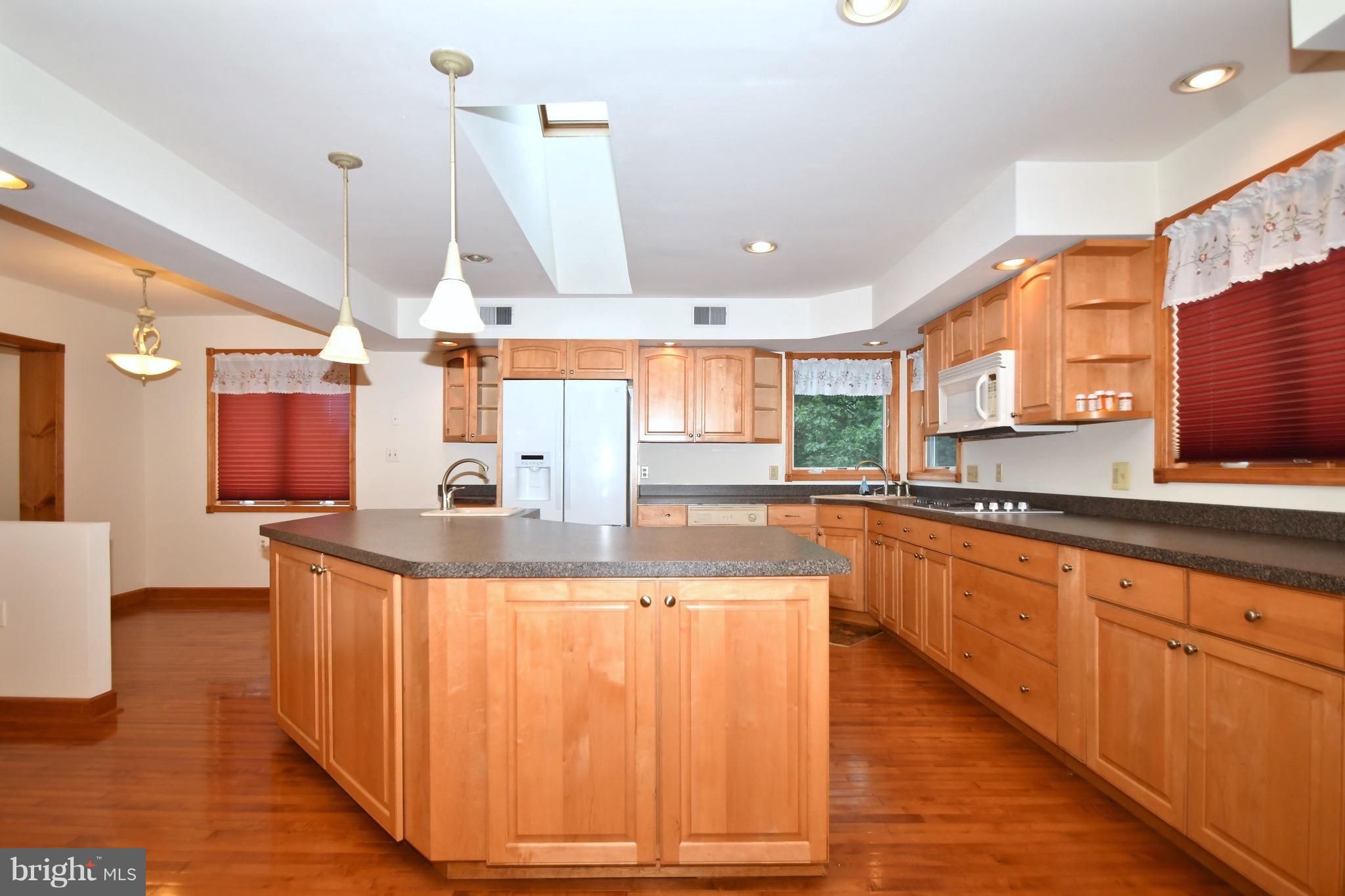 202 Sandhill Road Baltimore, MD 21221 - Photo 4 of 30 a large kitchen with granite countertop a sink and a stove