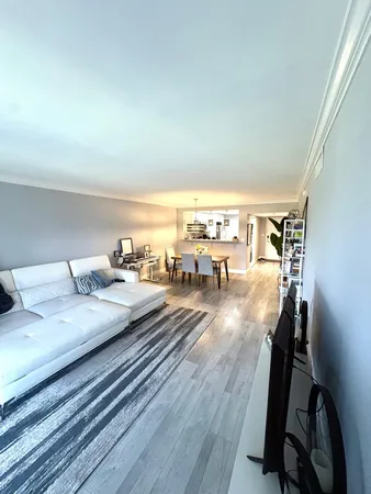 a living room with lots of furniture and a wooden floor