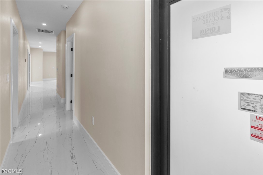 526 Knapp Street Lehigh Acres, FL 33974 - Photo 17 of 37 a view of a hallway with wooden floor