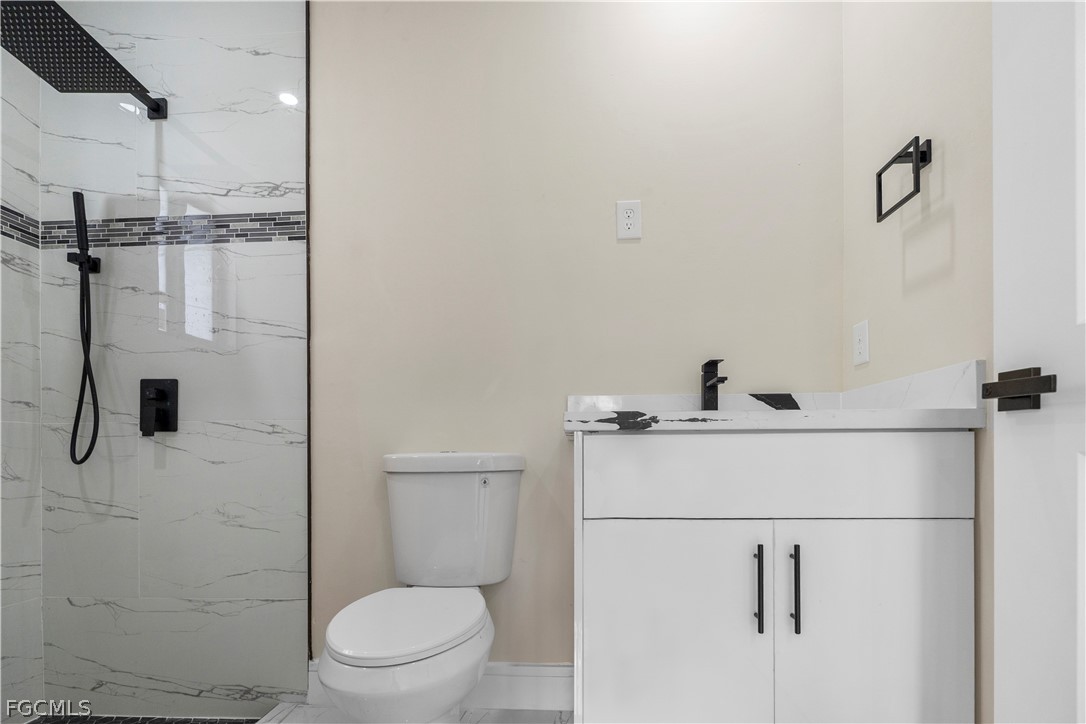 526 Knapp Street Lehigh Acres, FL 33974 - Photo 19 of 37 a bathroom with a toilet and a shower