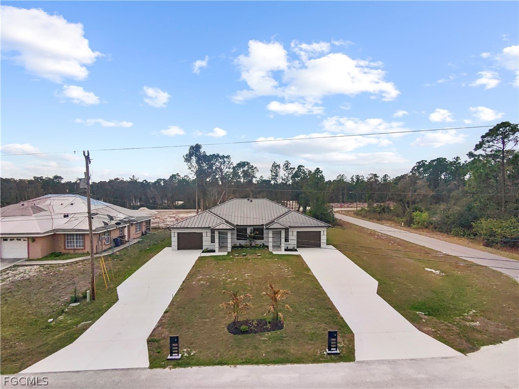 526 Knapp Street Lehigh Acres, FL 33974 - Photo 2 of 37 a view of a swimming pool with lounge chair