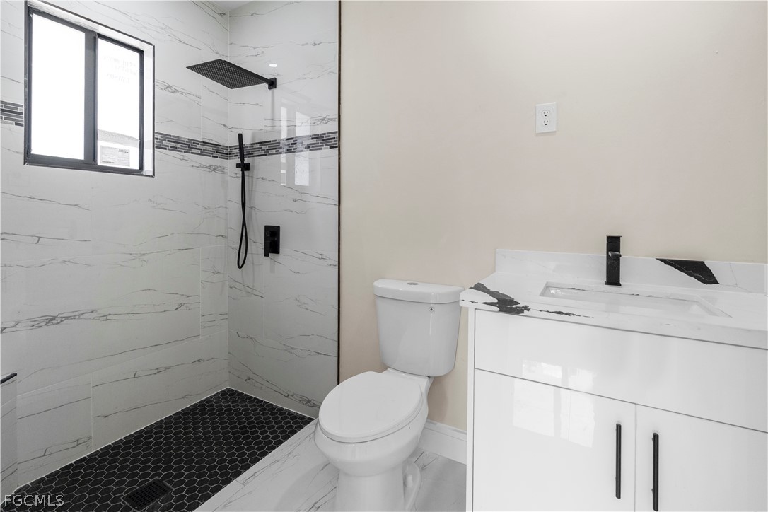 526 Knapp Street Lehigh Acres, FL 33974 - Photo 21 of 37 a bathroom with a sink and a toilet