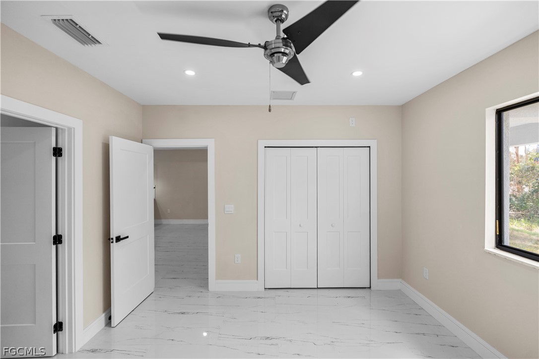 526 Knapp Street Lehigh Acres, FL 33974 - Photo 24 of 37 an empty room with windows and closet