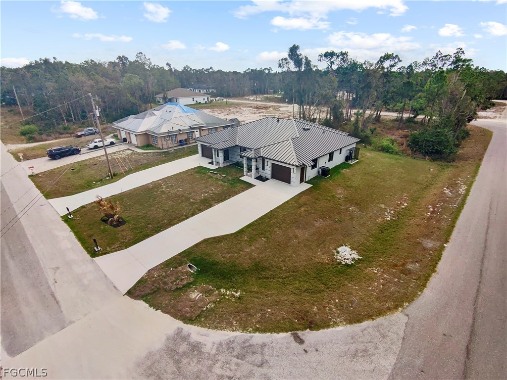 526 Knapp Street Lehigh Acres, FL 33974 - Photo 3 of 37 a view of a house with pool and mountains in the background