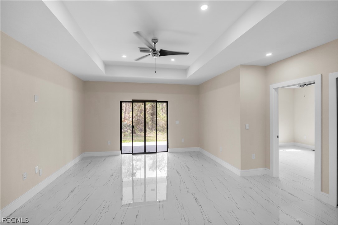 526 Knapp Street Lehigh Acres, FL 33974 - Photo 33 of 37 wooden floor in an empty room with a window