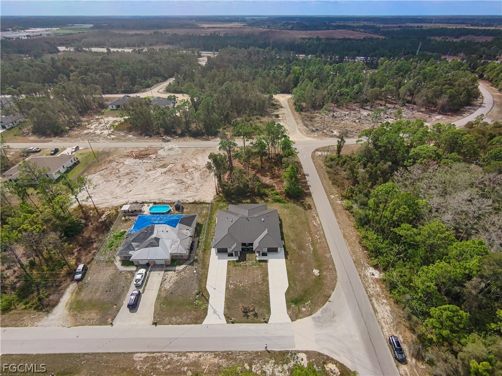 526 Knapp Street Lehigh Acres, FL 33974 - Photo 4 of 37 an aerial view of a house with a yard