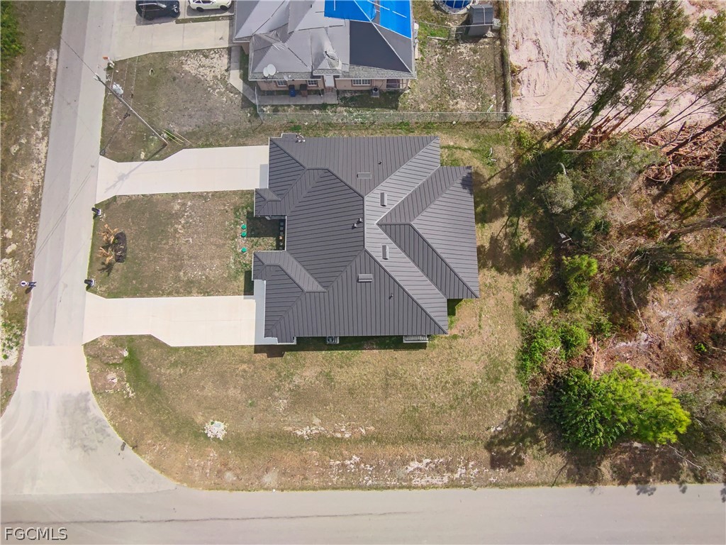 526 Knapp Street Lehigh Acres, FL 33974 - Photo 10 of 37 an aerial view of a house with a yard