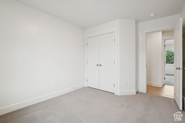1615 North Angel Street, Unit H Layton, UT 84041 - Photo 23 of 55 Unfurnished bedroom featuring light carpet and a closet