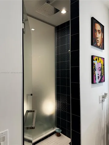 a bathroom with a shower and a sink