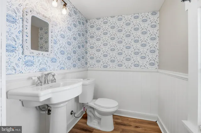 a bedroom with a bed a couch and a flat screen tv