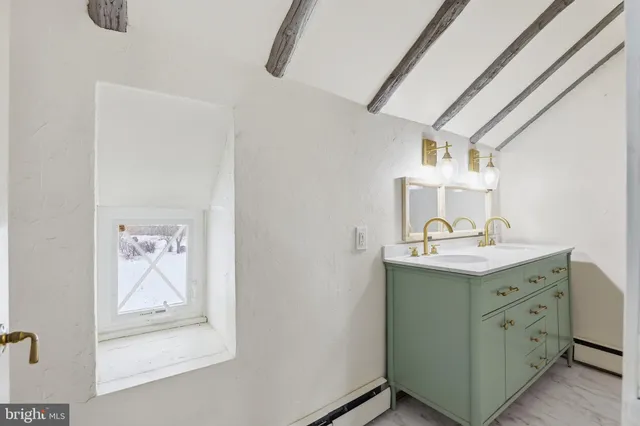 a bedroom with furniture and a window