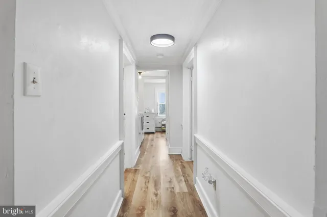 a room with a baby crib and a dresser