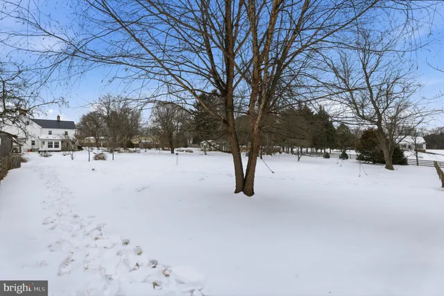 a view of a house with a snow in the yard