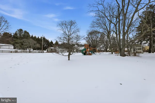a view of a terrace with chairs and iron fence