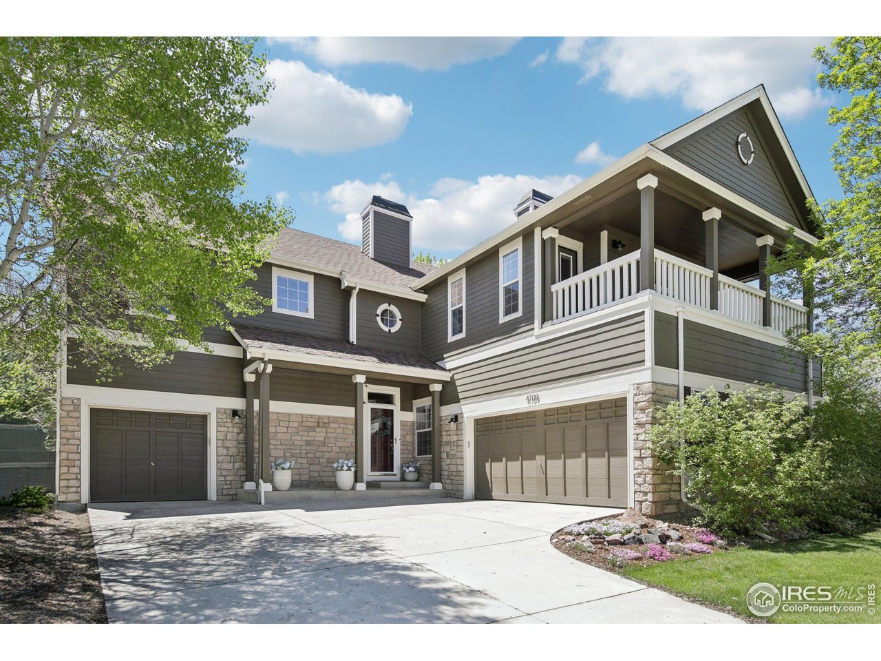 a front view of a house with a yard and potted plants