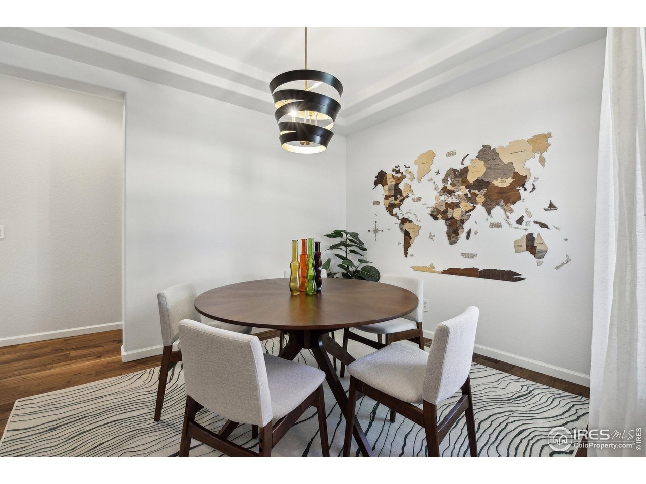 4109 Frederick Circle Longmont, CO 80503 - Photo 12 of 40 a view of a dining room with furniture and wooden floor