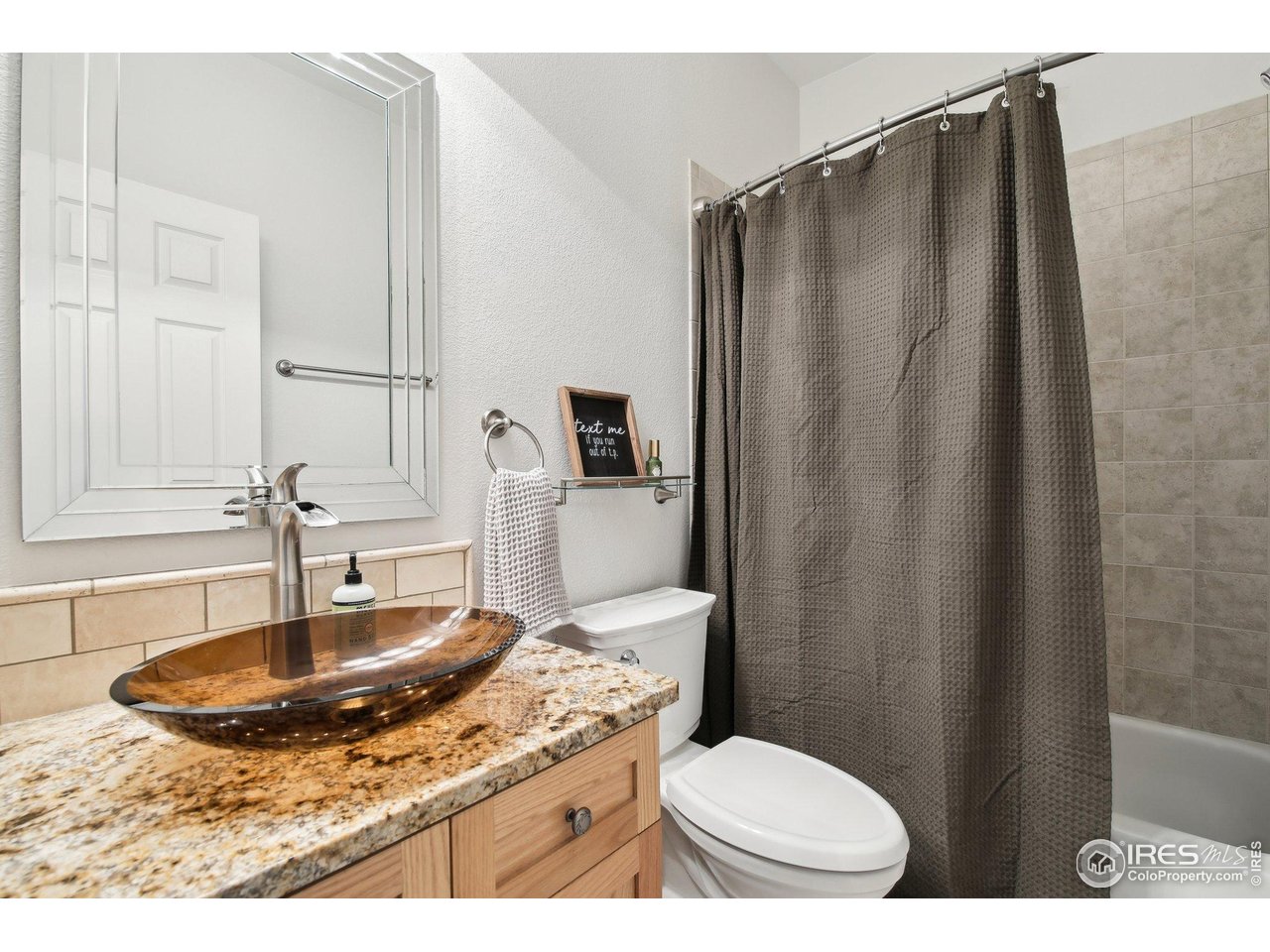 4109 Frederick Circle Longmont, CO 80503 - Photo 14 of 40 a bathroom with a sink toilet and mirror