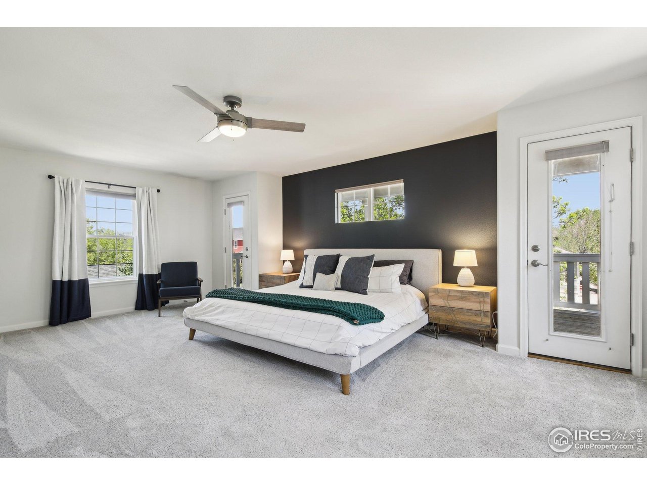 4109 Frederick Circle Longmont, CO 80503 - Photo 20 of 40 a spacious bedroom with a large bed and a chandelier