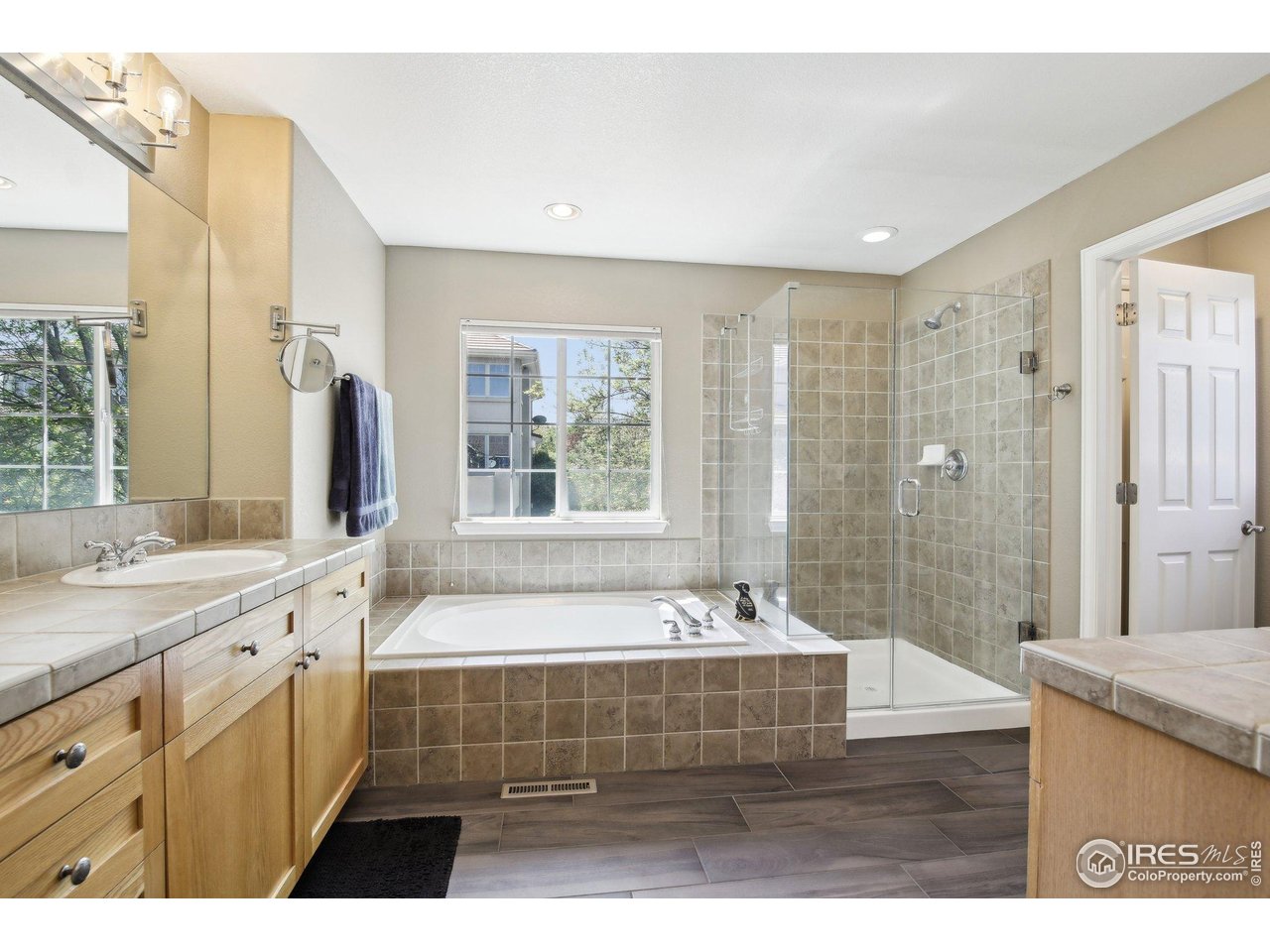4109 Frederick Circle Longmont, CO 80503 - Photo 25 of 40 a bathroom with a tub a sink and a shower