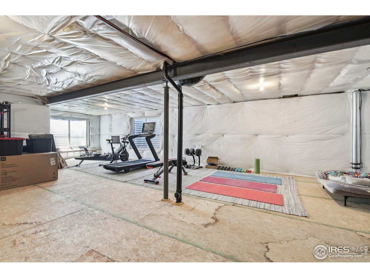 4109 Frederick Circle Longmont, CO 80503 - Photo 31 of 40 a room with gym equipment and a view of living room