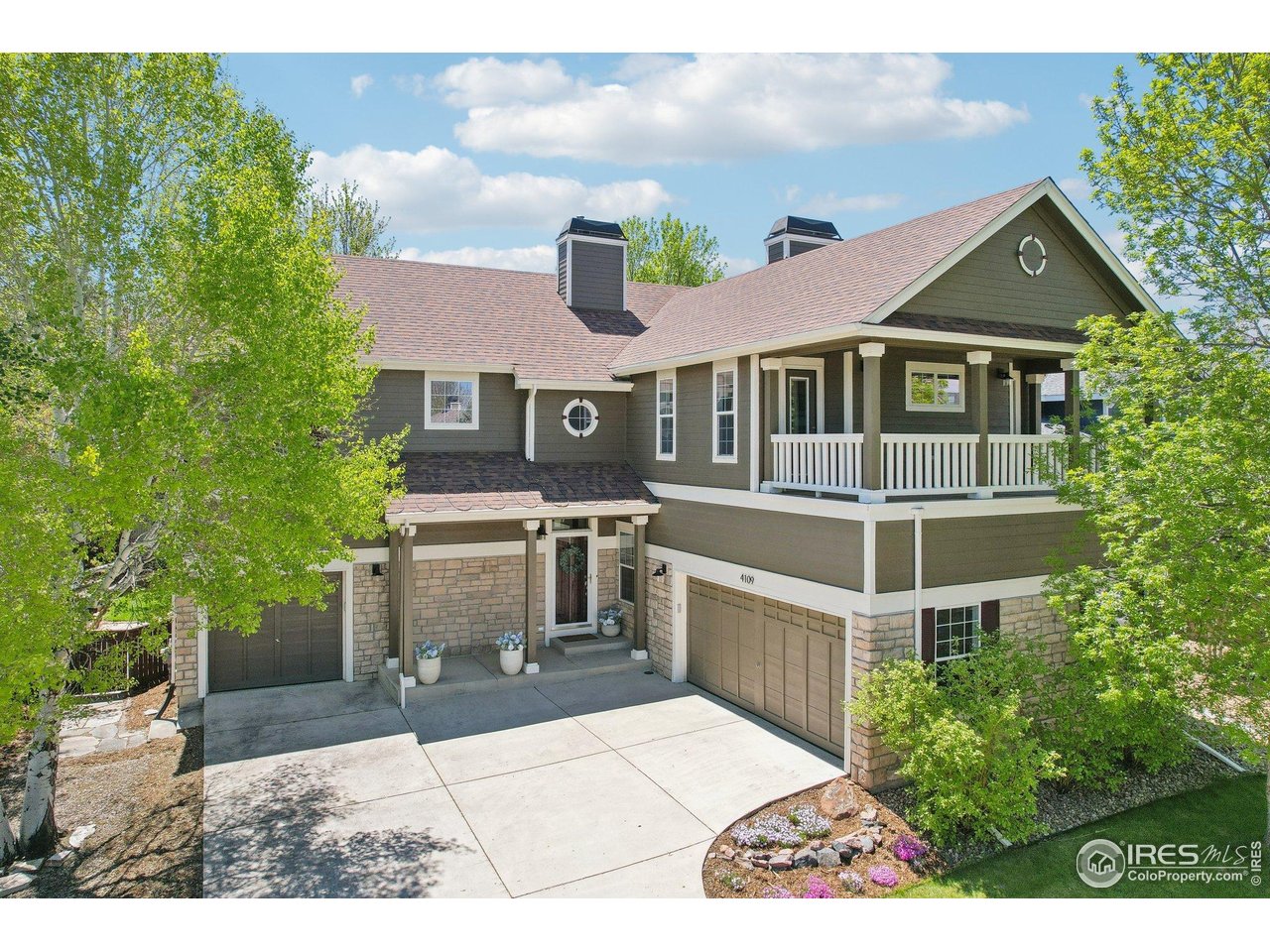 4109 Frederick Circle Longmont, CO 80503 - Photo 38 of 40 a front view of a house with a yard garage and outdoor seating
