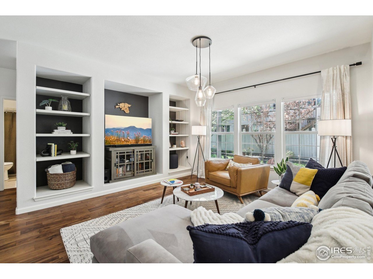 4109 Frederick Circle Longmont, CO 80503 - Photo 4 of 40 a living room with furniture wooden floor and floor to ceiling window