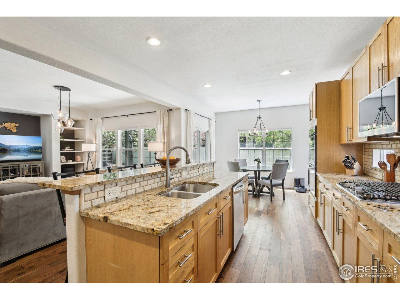 4109 Frederick Circle Longmont, CO 80503 - Photo 9 of 40 a open kitchen with stainless steel appliances granite countertop a lot of counter space and wooden floors