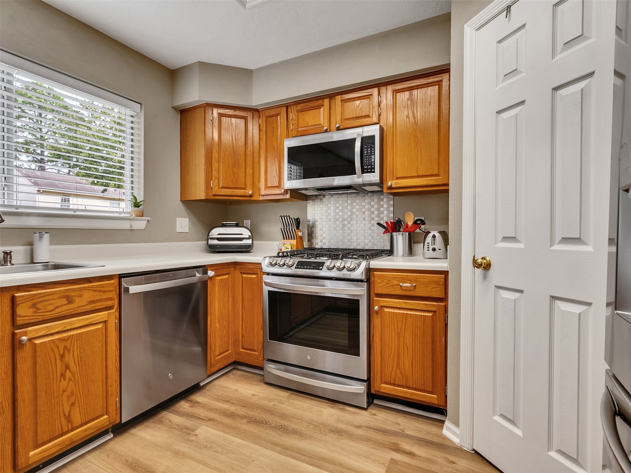 14219 Whitlock Drive Houston, TX 77062 - Photo 18 of 49 a kitchen with stainless steel appliances granite countertop a stove a sink and a microwave
