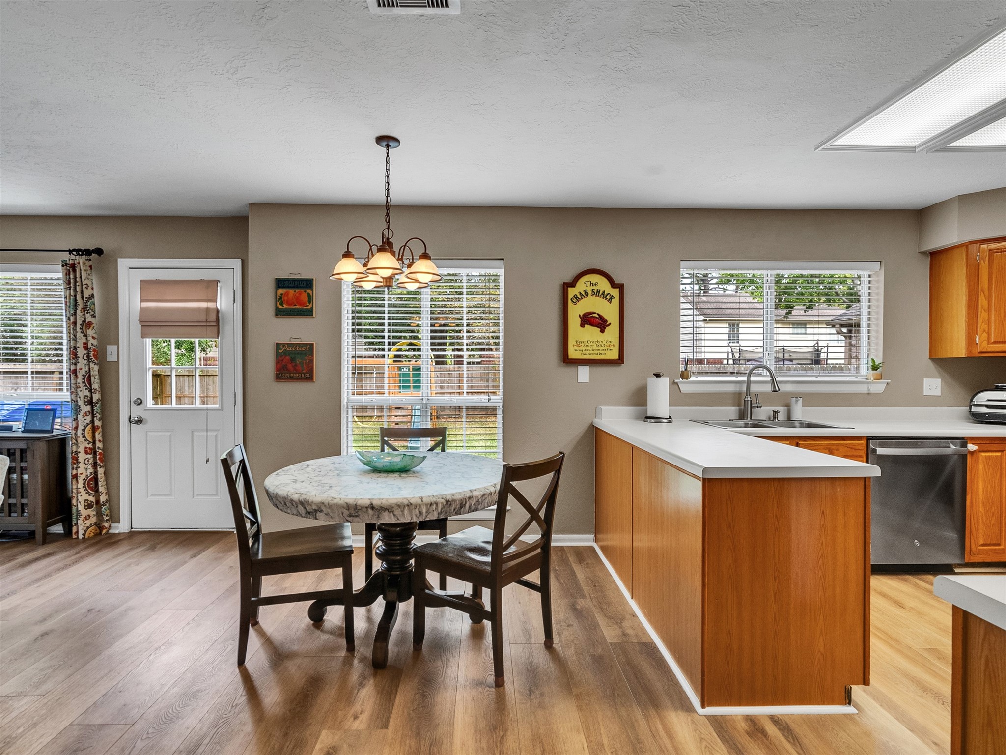 14219 Whitlock Drive Houston, TX 77062 - Photo 19 of 49 a dining room with furniture a chandelier and wooden floor