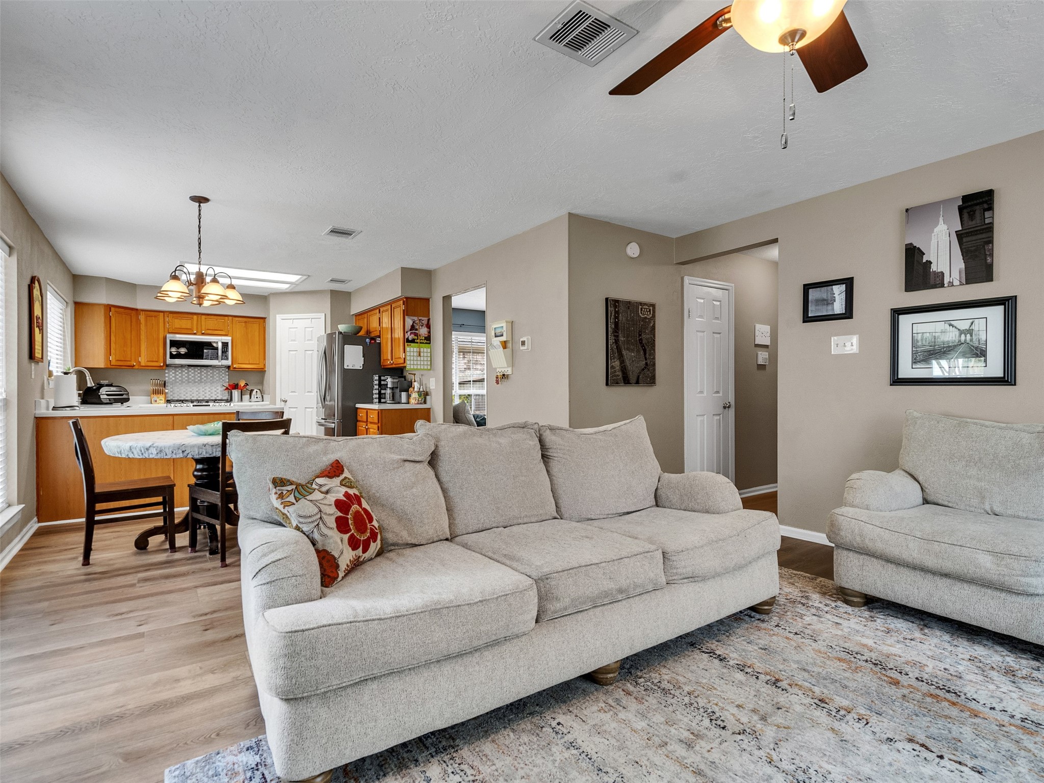 14219 Whitlock Drive Houston, TX 77062 - Photo 23 of 49 a living room with furniture kitchen view and a wooden floor