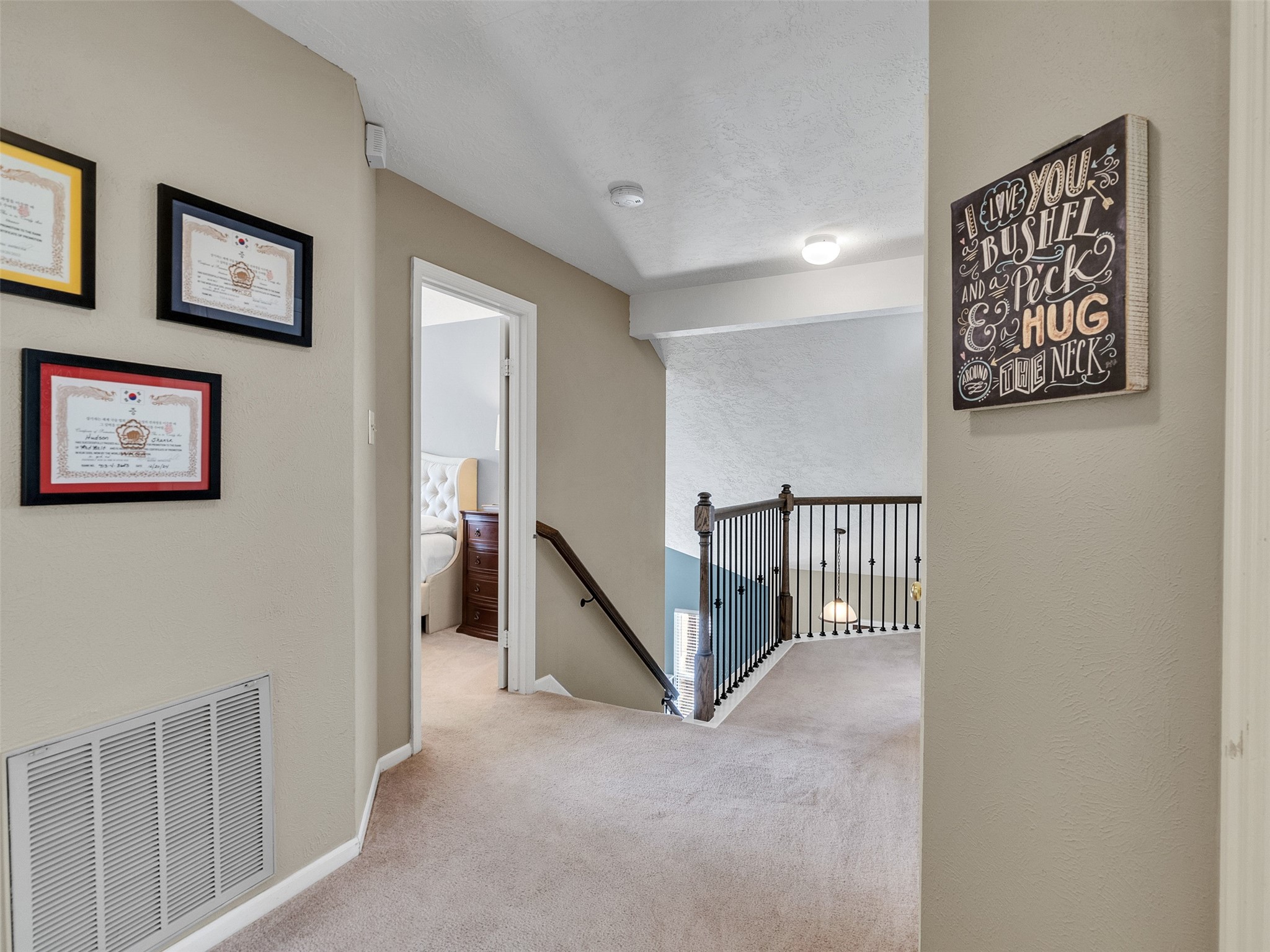 14219 Whitlock Drive Houston, TX 77062 - Photo 32 of 49 a view of a hallway with paintings on the wall