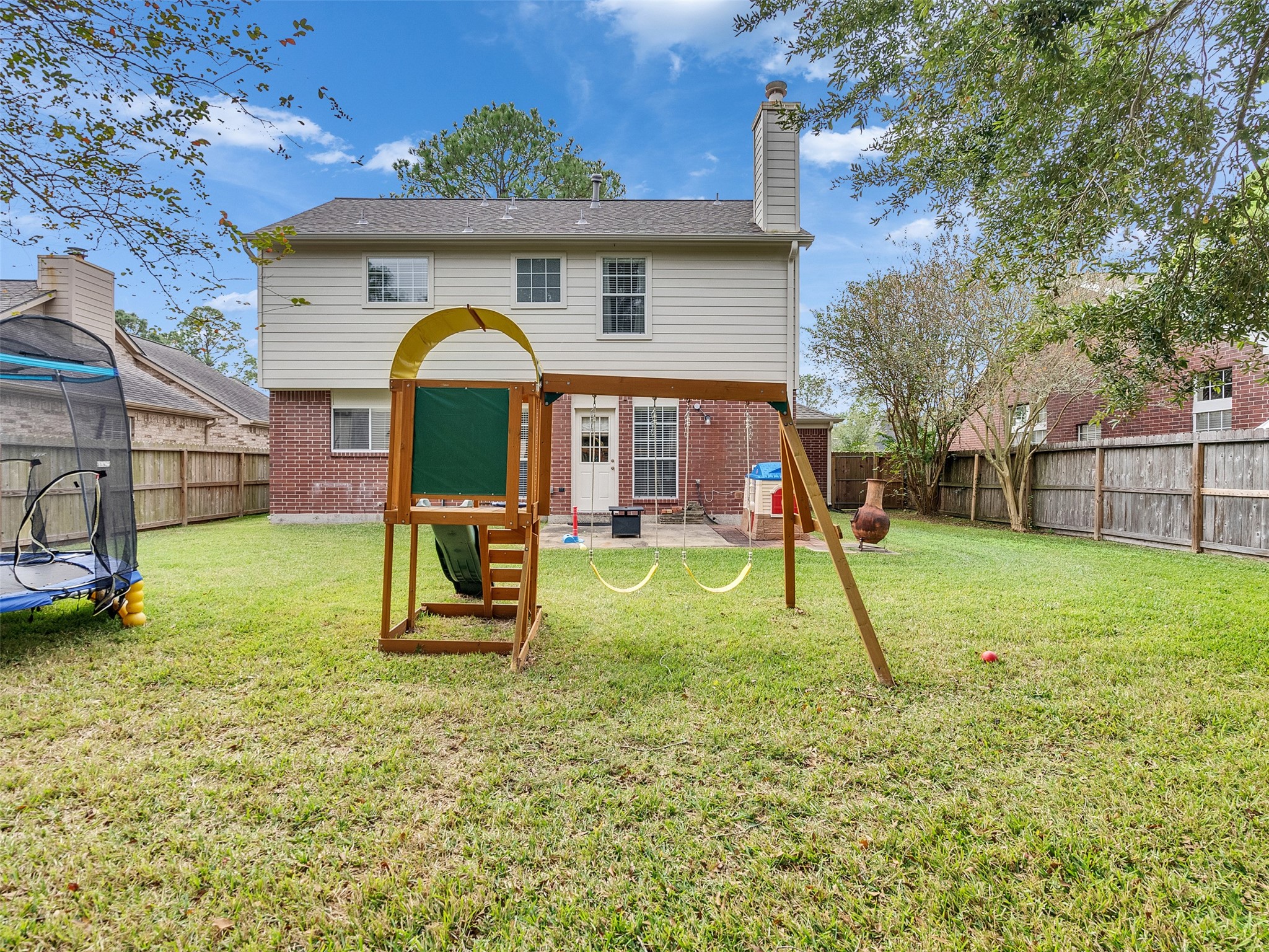 14219 Whitlock Drive Houston, TX 77062 - Photo 47 of 49 a view of a house with a backyard and a slide