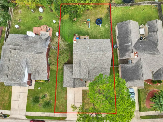 an aerial view of a house with a garden and trees