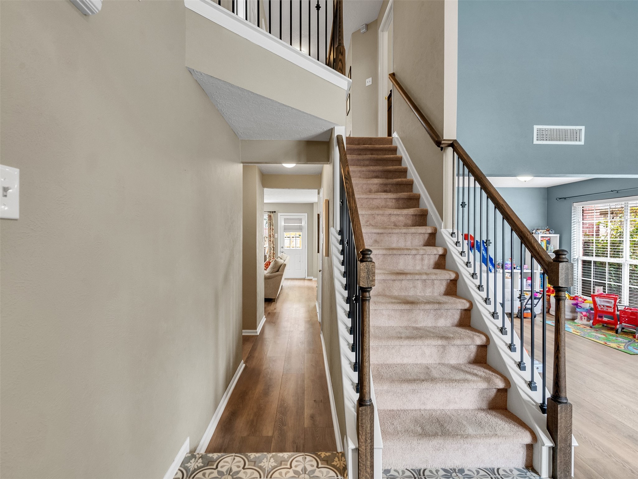 14219 Whitlock Drive Houston, TX 77062 - Photo 6 of 49 a view of staircase with wooden floor and white walls