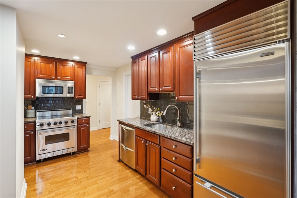 20 Chapel Street, Unit B811 Brookline, MA 02446 - Photo 12 of 33 a kitchen with stainless steel appliances granite countertop a stove and a sink