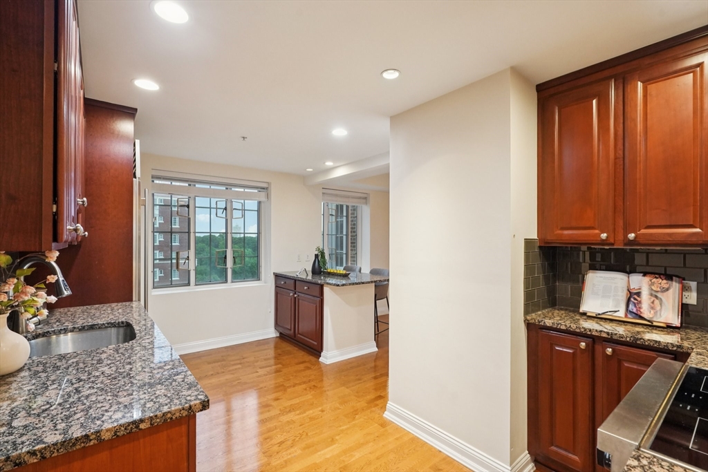 20 Chapel Street, Unit B811 Brookline, MA 02446 - Photo 14 of 33 a view of a kitchen with kitchen island granite countertop stainless steel appliances stove sink and tub