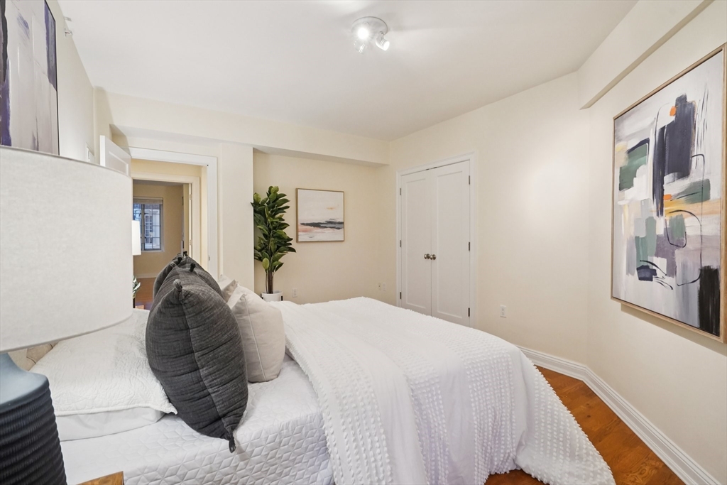 20 Chapel Street, Unit B811 Brookline, MA 02446 - Photo 17 of 33 a bed room with a bed and a painting on the wall