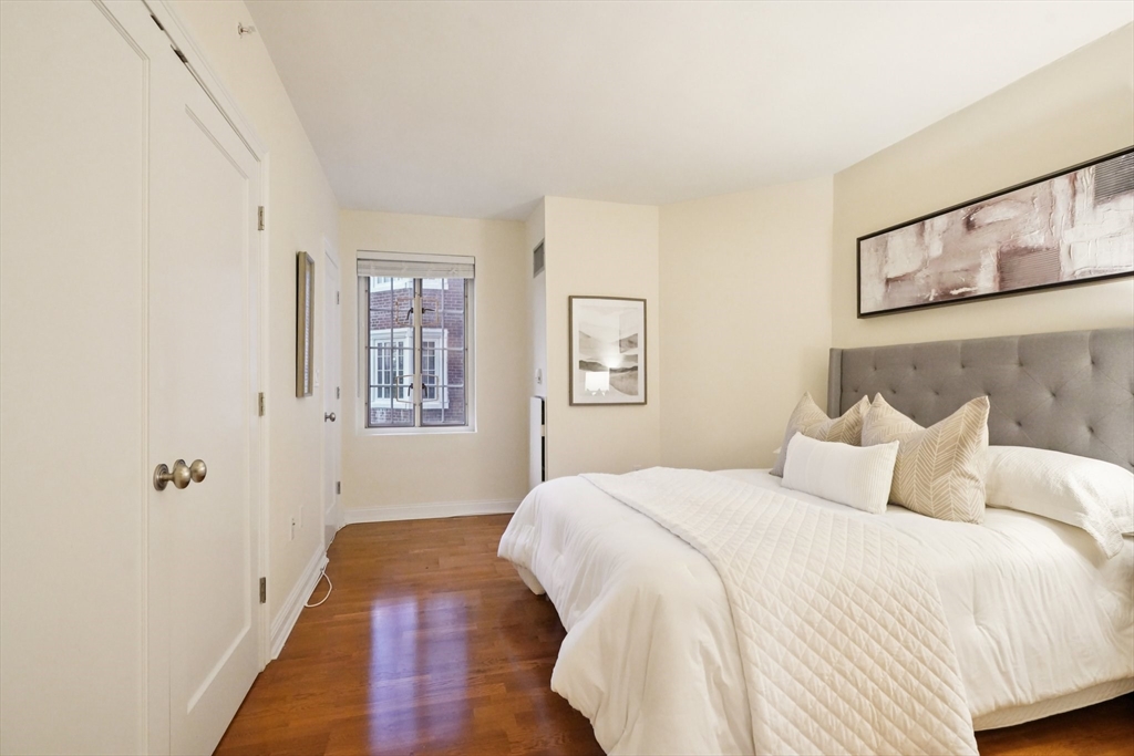 20 Chapel Street, Unit B811 Brookline, MA 02446 - Photo 19 of 33 a bedroom with a bed and a window