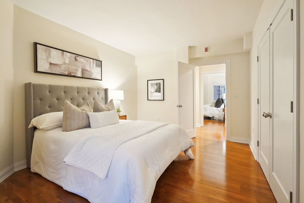 20 Chapel Street, Unit B811 Brookline, MA 02446 - Photo 20 of 33 a en suite spacious bedroom with a bed and a painting on the wall
