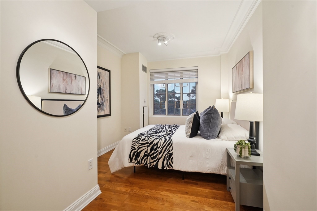 20 Chapel Street, Unit B811 Brookline, MA 02446 - Photo 22 of 33 a bedroom with a bed and a large window