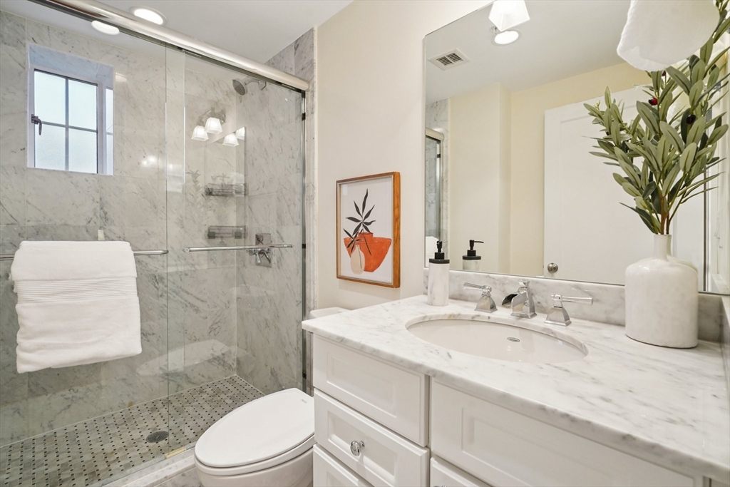 20 Chapel Street, Unit B811 Brookline, MA 02446 - Photo 25 of 33 a bathroom with a sink a toilet and shower