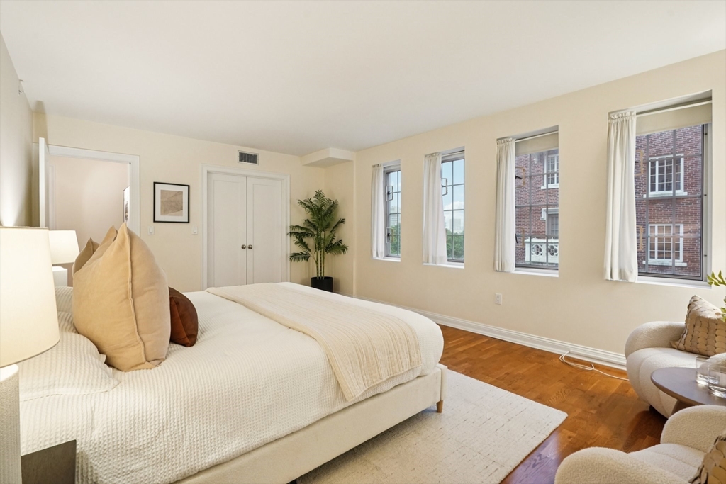 20 Chapel Street, Unit B811 Brookline, MA 02446 - Photo 27 of 33 a bedroom with a large bed and wooden floor