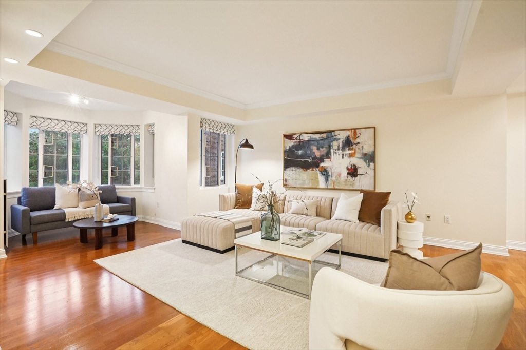 20 Chapel Street, Unit B811 Brookline, MA 02446 - Photo 3 of 33 a living room with furniture and wooden floor