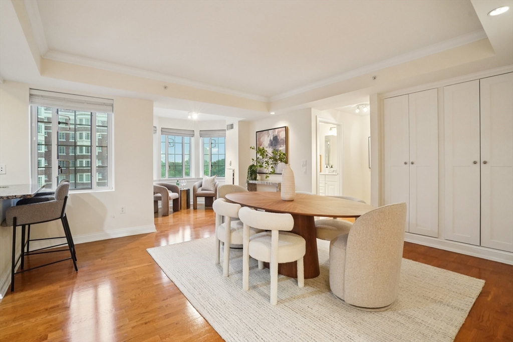 20 Chapel Street, Unit B811 Brookline, MA 02446 - Photo 6 of 33 a view of a dining room with furniture and wooden floor